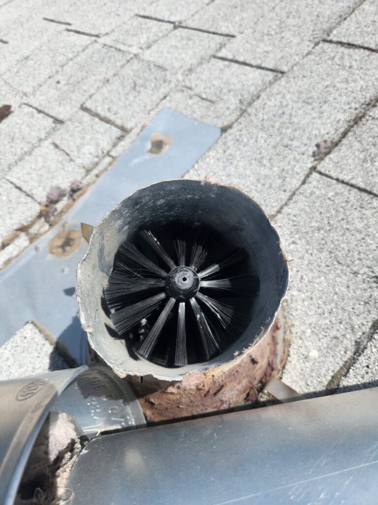Dryer roof vent being cleaned